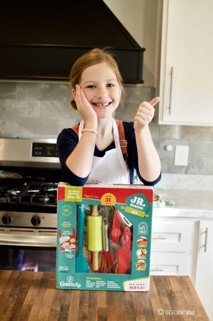 Girl posing with Baketivity Accessory Kit in this Baketivity for Homeschoolers Review