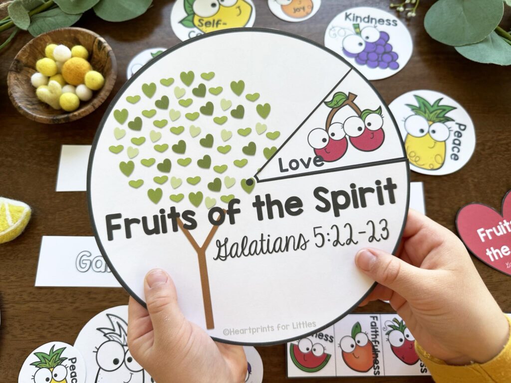 Round spinner with Fruits of Spirit Galatians 5:22-23 text on it and picture of tree and fruit.