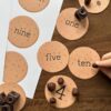 cookie-counting-numbers-preschool Numbered cookie counters with words and numbers for homeschool math activities, focusing on number recognition and counting skills.