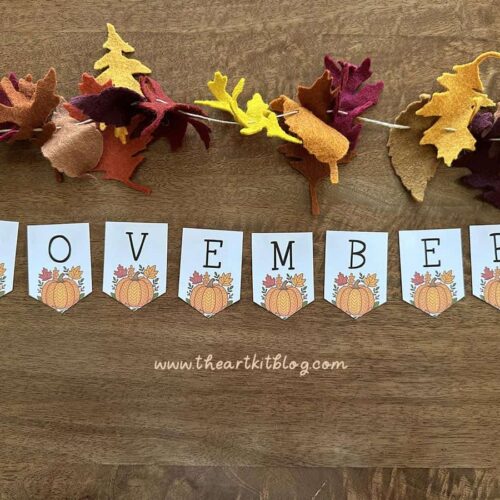 Colorful felt autumn leaf garland and "November" banner for homeschool classroom or fall decorating, featuring pumpkin-themed flags and seasonal decorations perfect for homeschooling or educational activities.