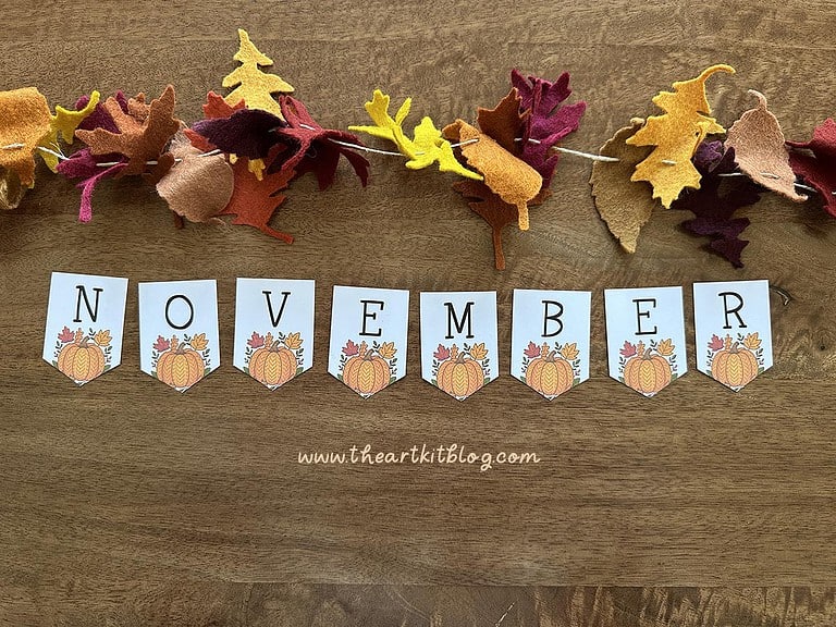 november-banner-pumpkin-printable-1 Colorful felt autumn leaf garland and "November" banner for homeschool classroom or fall decorating, featuring pumpkin-themed flags and seasonal decorations perfect for homeschooling or educational activities.