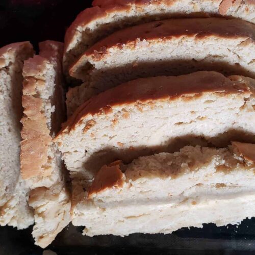 Sliced homemade bread with a golden crust, perfect for homeschooling snack time or breakfast. Freshly baked, soft interior, ideal for family meals and educational activities.