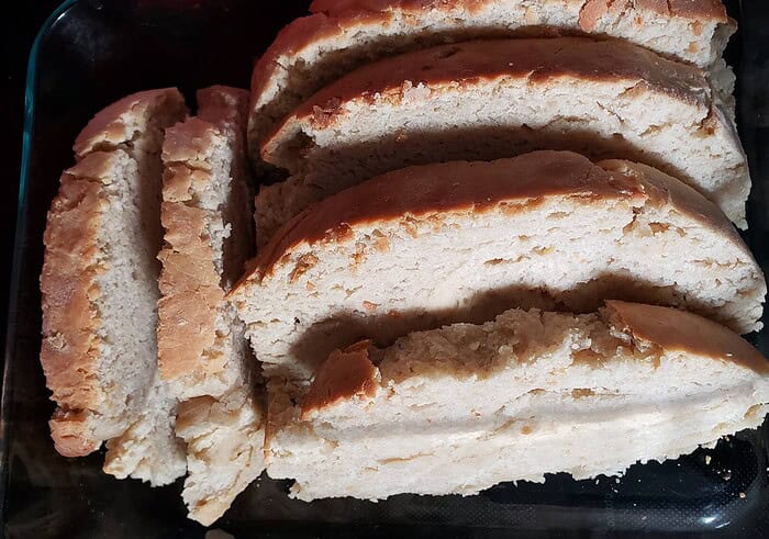 Homeschool Resource Co. Sliced homemade bread with a golden crust, perfect for homeschooling snack time or breakfast. Freshly baked, soft interior, ideal for family meals and educational activities.