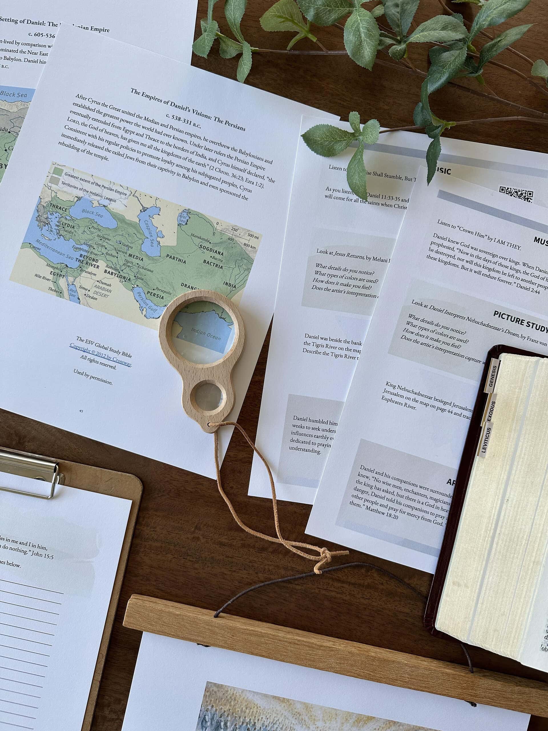 Educational homeschool planning materials with maps and notebooks.