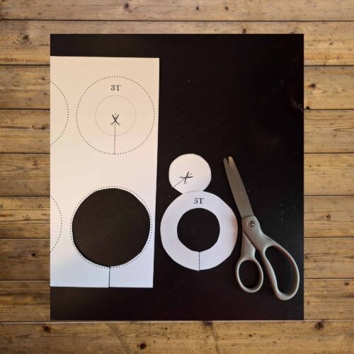 Printable target practice templates for homeschooling, featuring different sizes for shooting or archery activities, with scissors for cutting out the targets.