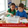 Two children conducting a science experiment with a clear water tank in a classroom setting.