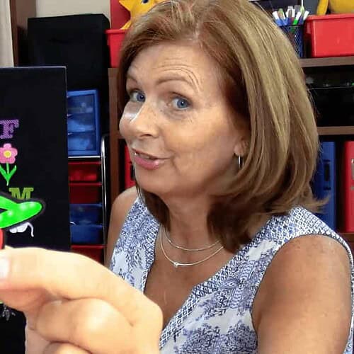 Woman demonstrating felt alphabet and animal shapes for homeschooling activities.