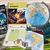 Educational geography books, globe, and maps for homeschooling, focusing on world and elementary geography lessons.