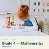 clareza-grade4-mathematics.jpg Young girl with red hair studying math at a desk in a homeschool classroom with educational posters and alphabet charts.