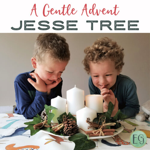 3 Two young boys smiling and looking at a festive Advent centerpiece with candles and pinecones.