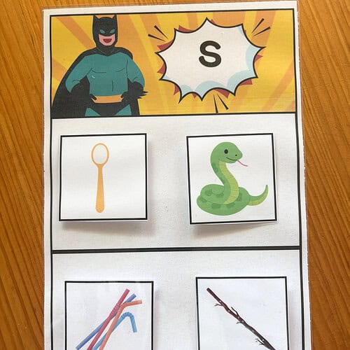 Educational worksheet featuring images of a spoon, snake, and sticks for early learning activities.