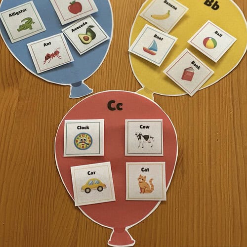 Educational alphabet balloon flashcards for homeschooling with images of animals, fruits, and objects.