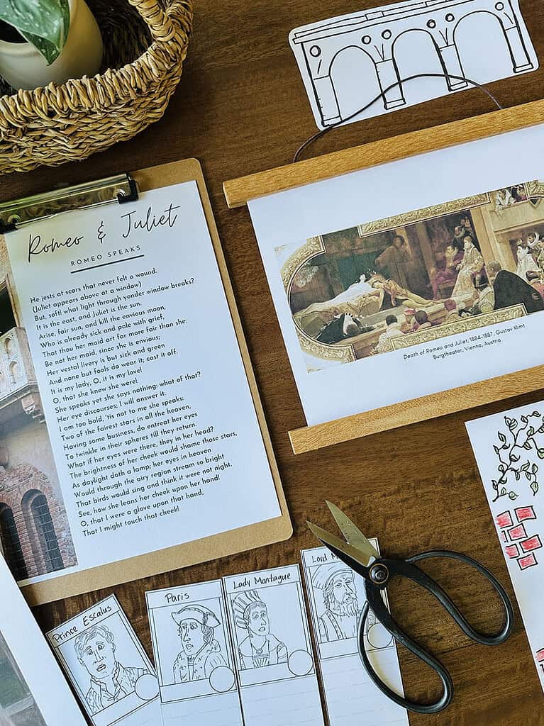 CM_SALE_RomeoJuliet_TheArtKit_2 Educational materials for homeschooling including a Romeo and Juliet script, historical images, and character sketches on a wooden desk.